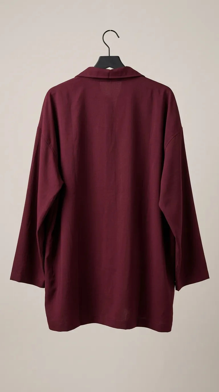 Back view of the maroon oversized shirt on a hanger
