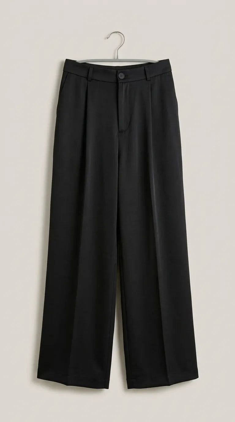 Black pleated wide-leg trousers hanging on a hanger, front view