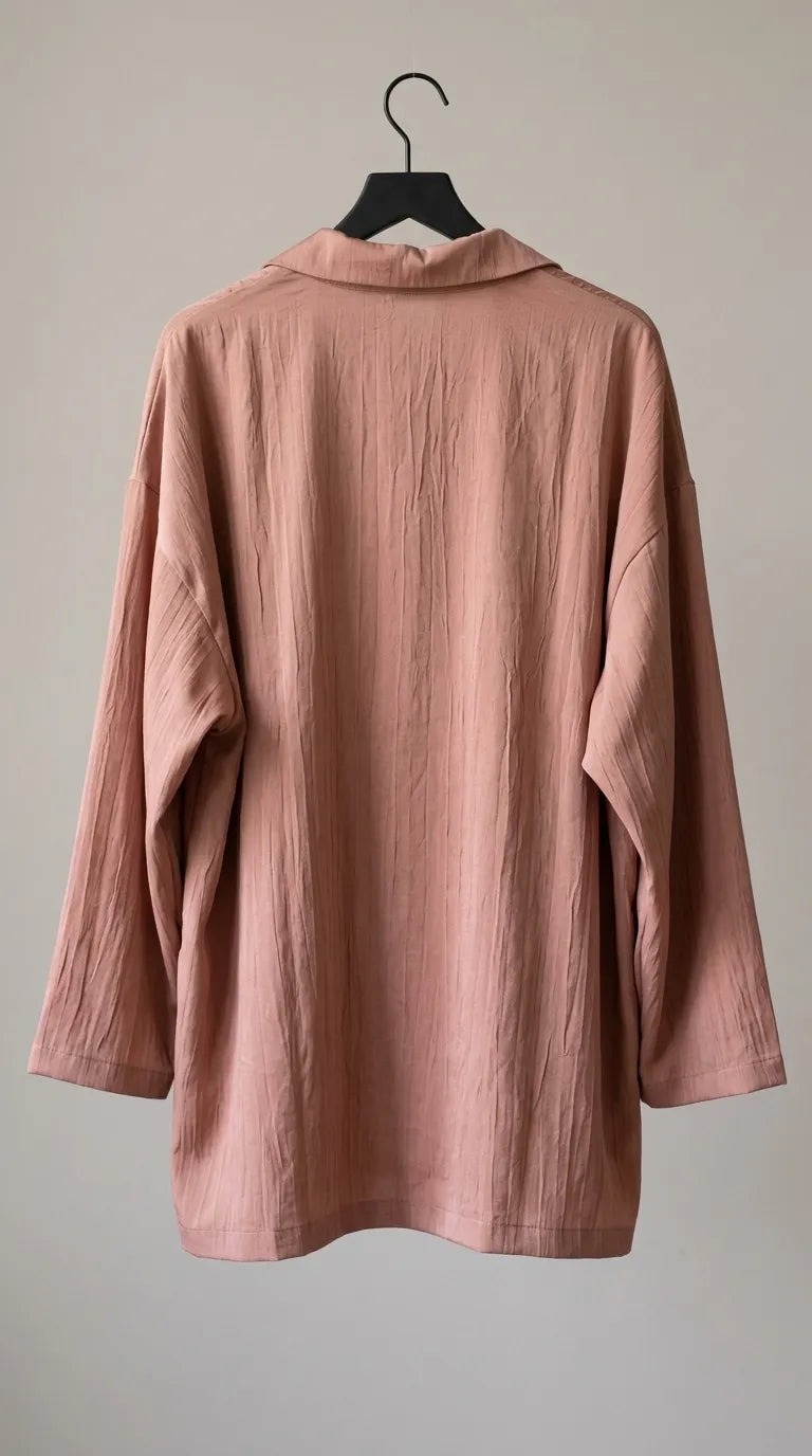 Back view of the dusty peach crinkled-crepe shirt on a hanger