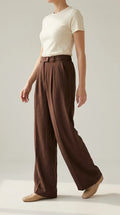 Chocolate brown wide-leg trousers worn by a model, side view mid-step